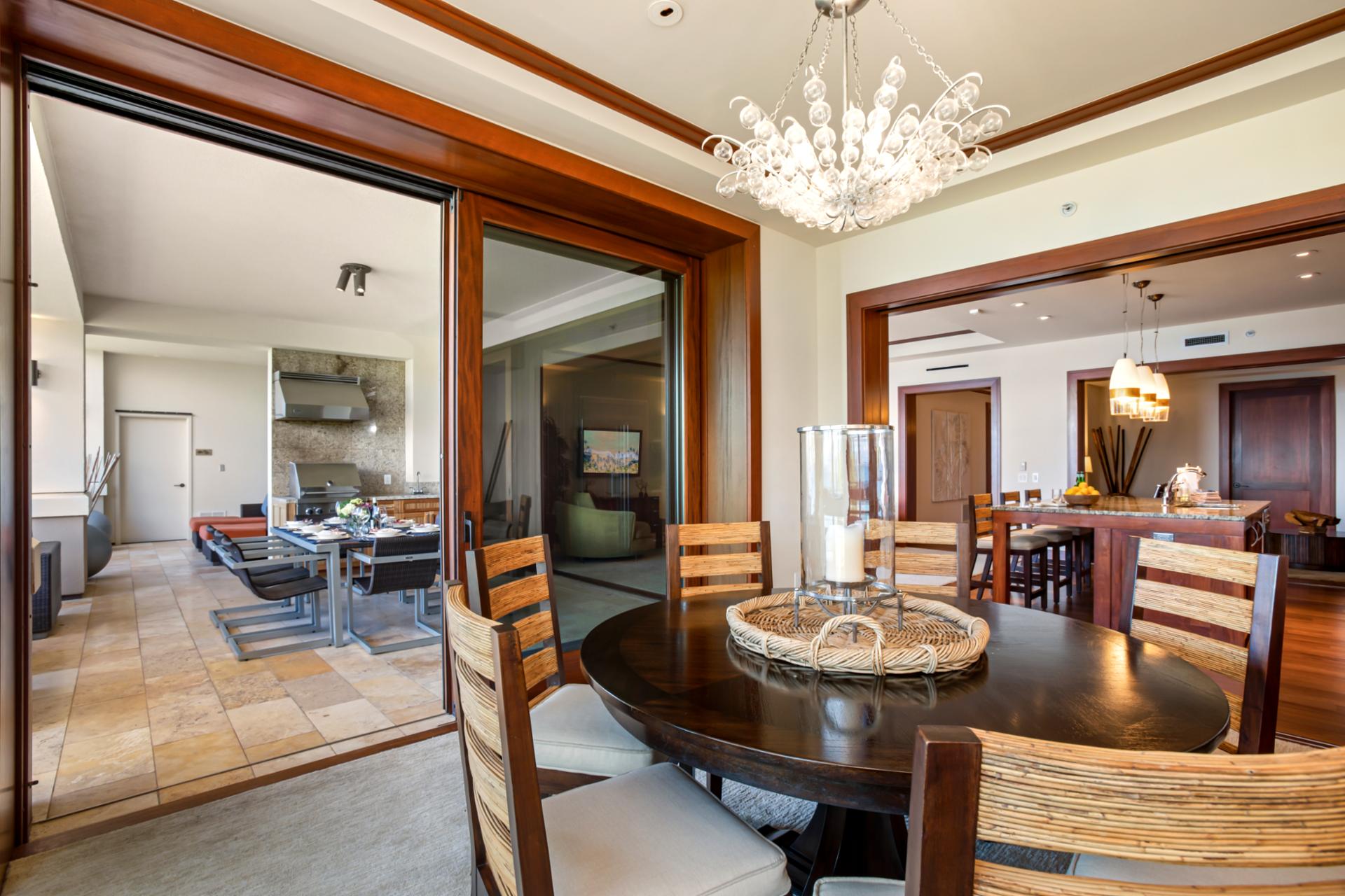 Chic dining room with glass doors opening to a breezy balcony