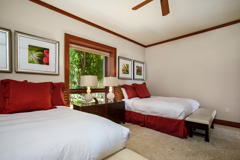 This queen bed guest suite is bright, cheerful, and perfect for family stays MON-1303