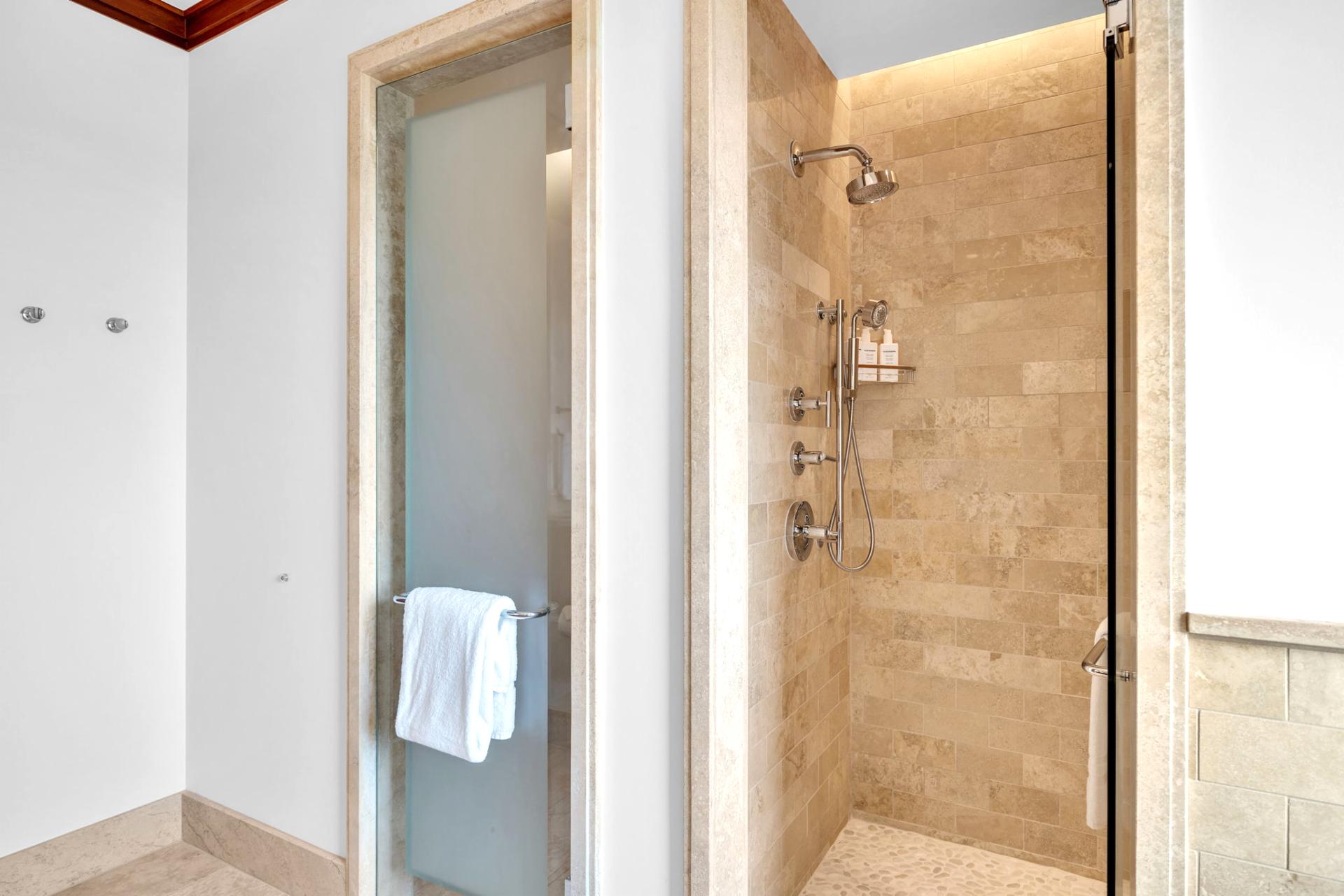 Walk-in stone shower and clean finishes for a comfortable guest bath experience

