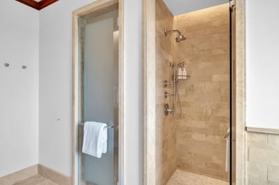 Walk-in stone shower and clean finishes for a comfortable guest bath experience