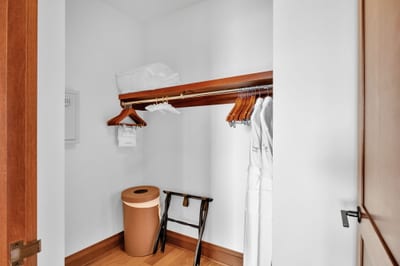 Ample guest closet with shelving and thoughtful storage space