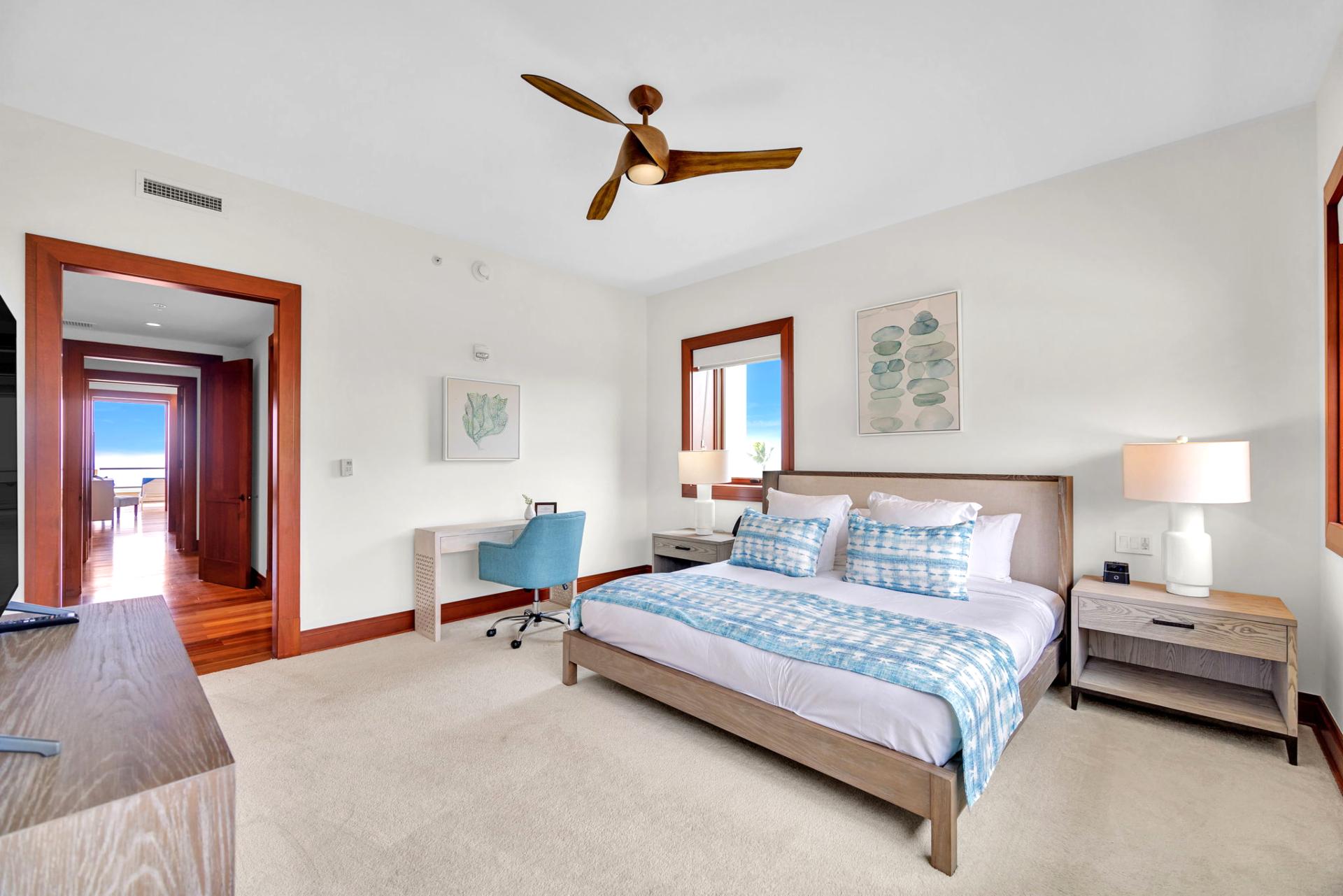 Tranquil guest suite with plush bedding and convenient desk space for any business needs 