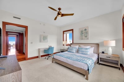 Tranquil guest suite with plush bedding and convenient desk space for any business needs