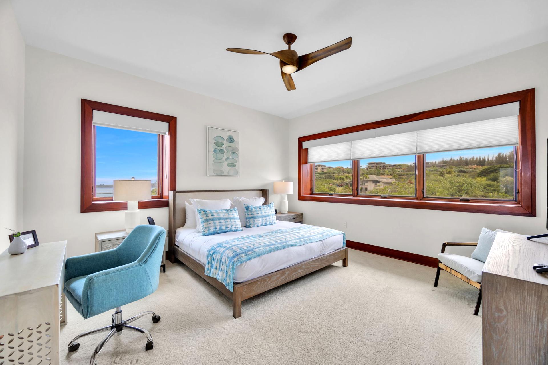 Guest bedroom with bright windows and ocean glimpses ideal for a peaceful stay

