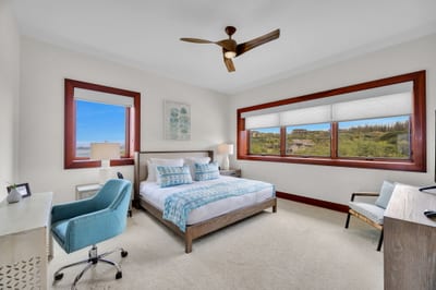 Guest bedroom with bright windows and ocean glimpses ideal for a peaceful stay