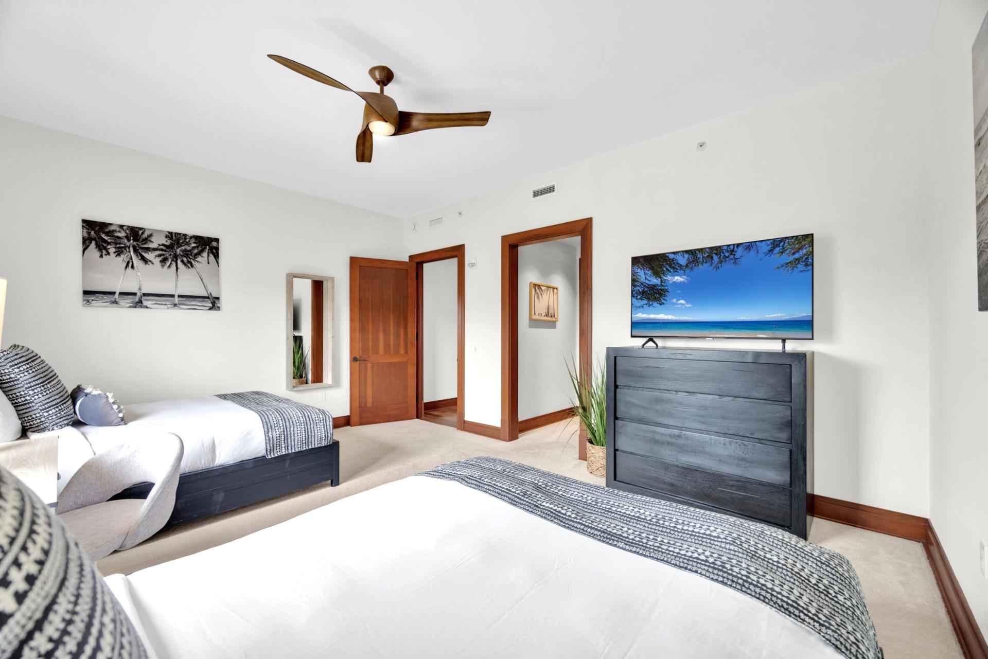Bright and airy guest room with twin beds and coastal views