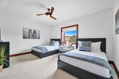 Guest bedroom two with two beds and natural tones for flexible family comfort