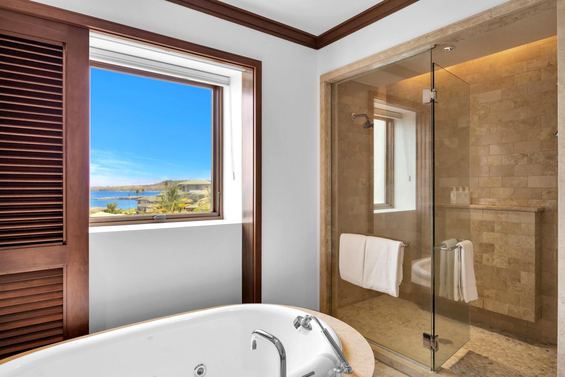 Natural stone finishes and sleek glass shower bring a modern touch to the master bath