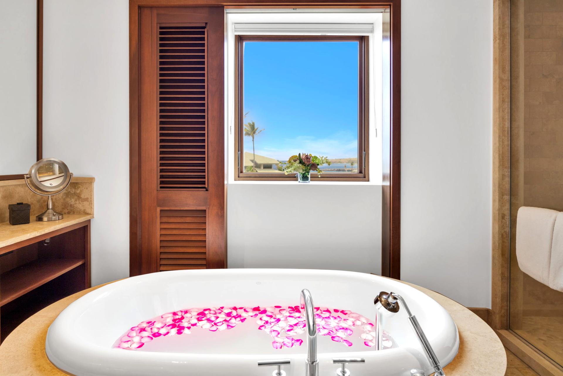Setup your romantic bath with rose petals and natural light for a serene escape
