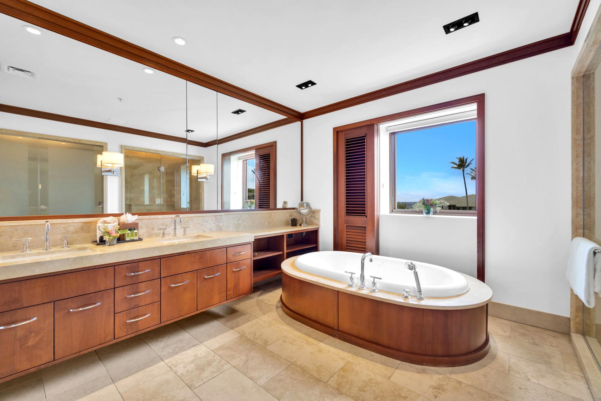 Elegant master bath featuring dual vanities and a panoramic window beside a freestanding tub
