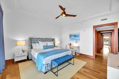 Elegant master retreat with designer headboard and warm natural light
