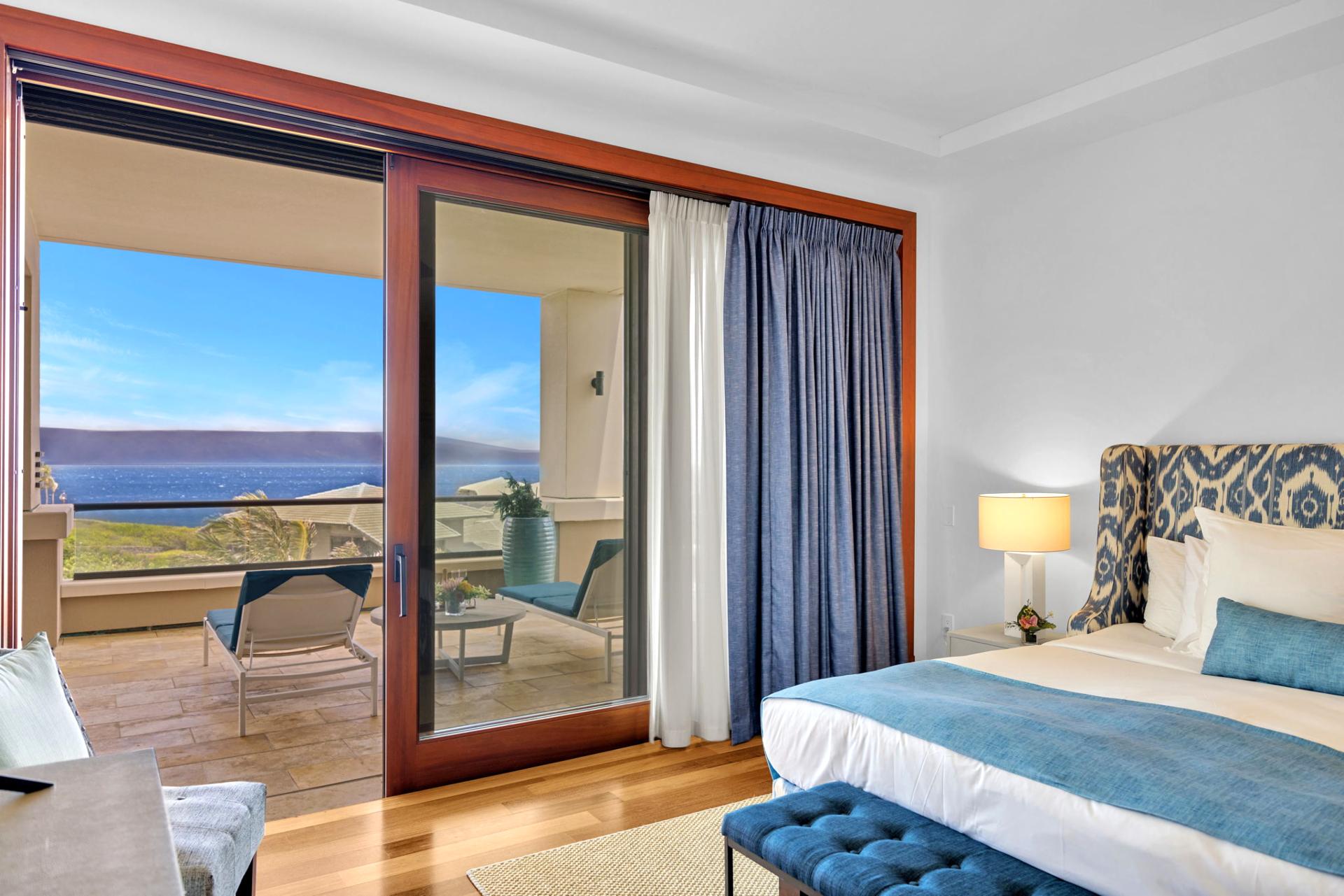 Master bedroom with plush bedding and balcony access to ocean serenity