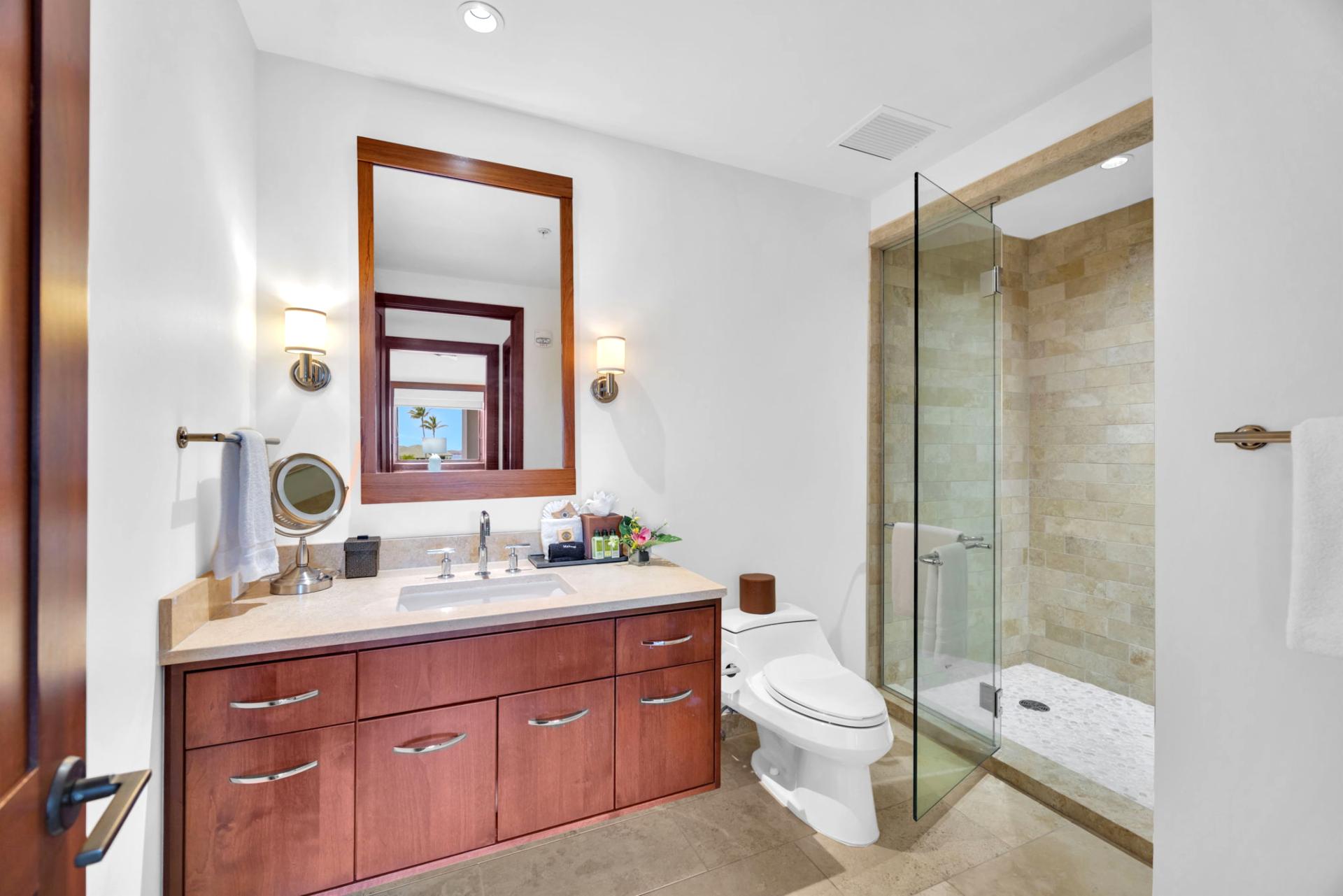 Stylish guest bath with granite vanity and glass walk-in shower

