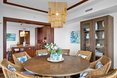 Beautiful woven dining chairs and wood table perfect for tropical gatherings or family dinner