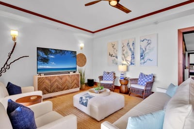 Cozy up with loved ones in this inviting lounge with coastal character