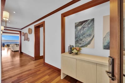 Elegant entryway with warm wood floors and artful island decor