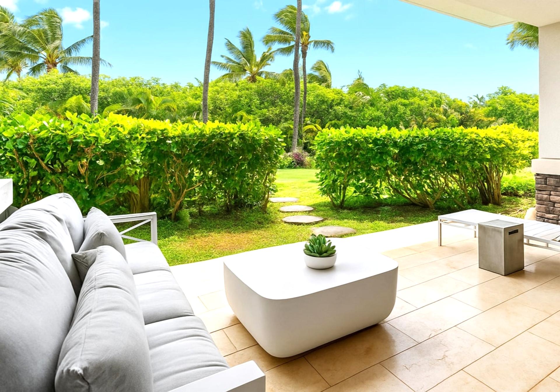 The spacious lanai with various seating options opens up to a stunning garden area