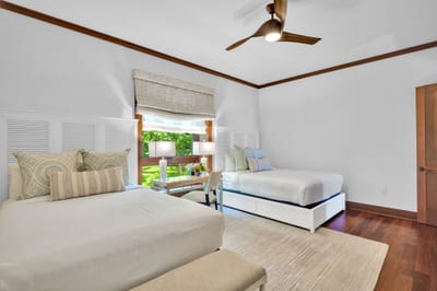The large window in the second guest bedroom offers a stream of natural light