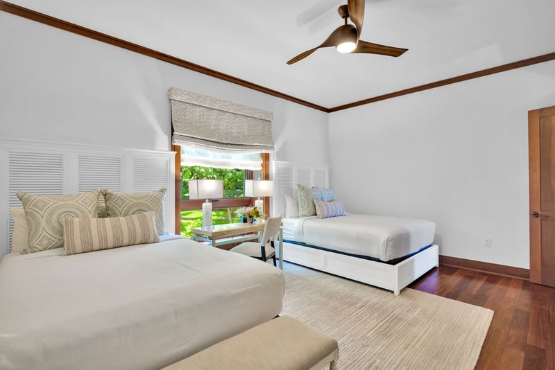 The large window in the second guest bedroom offers a stream of natural light