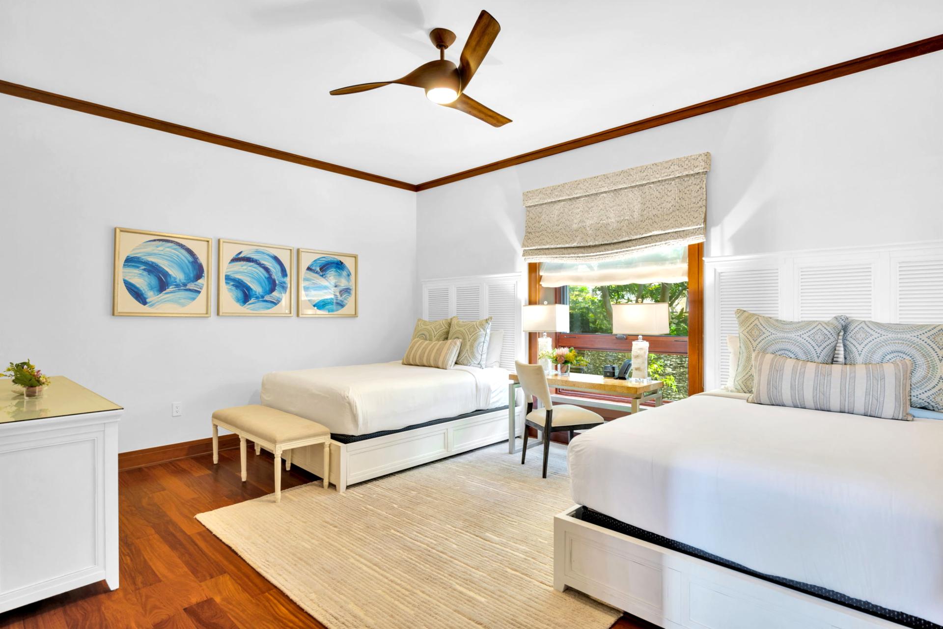 The second guest bedroom features two queen size beds, perfect for children or additional guests