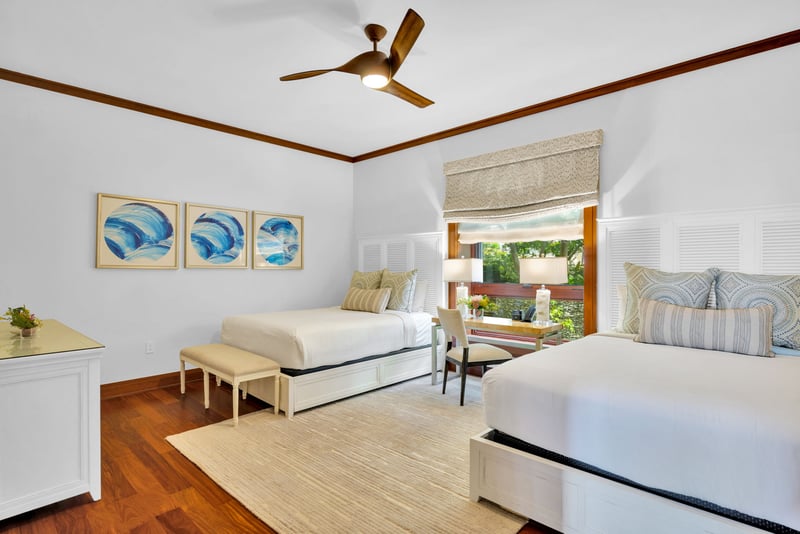 The second guest bedroom features two queen size beds, perfect for children or additional guests