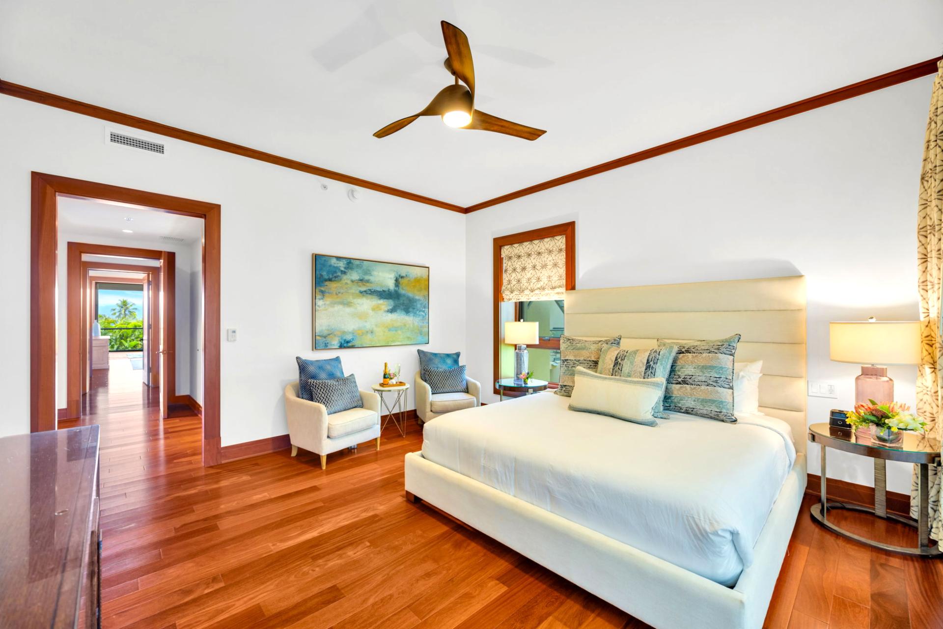 The spacious guest bedroom features tropical-inspired decor