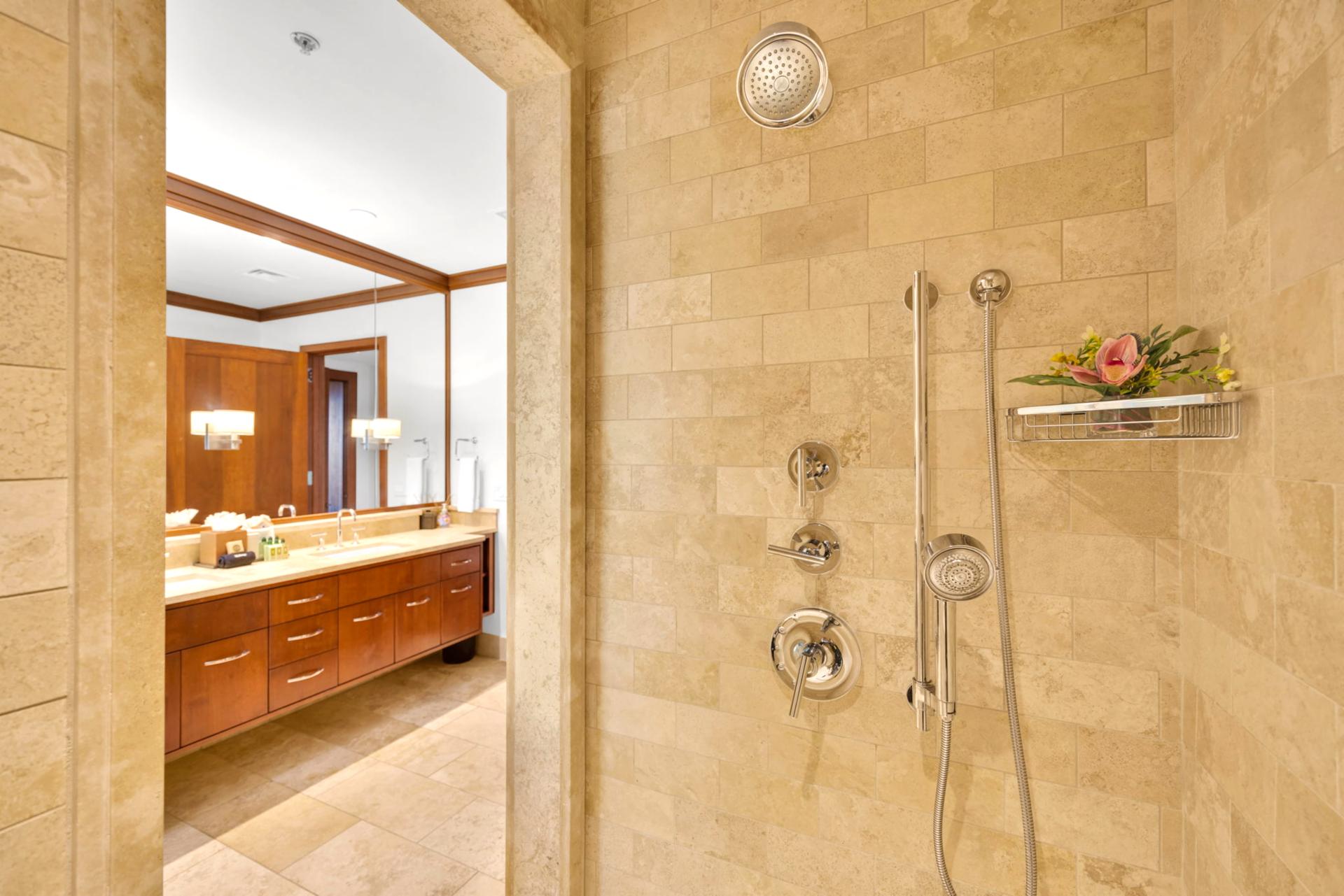 The walk in shower features a sleek tile design 