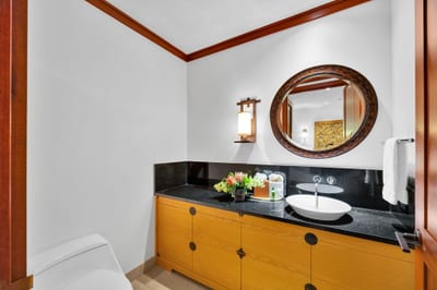 The hall bath features an elegant black marble countertop and is perfect for touching up before heading out to dinner
