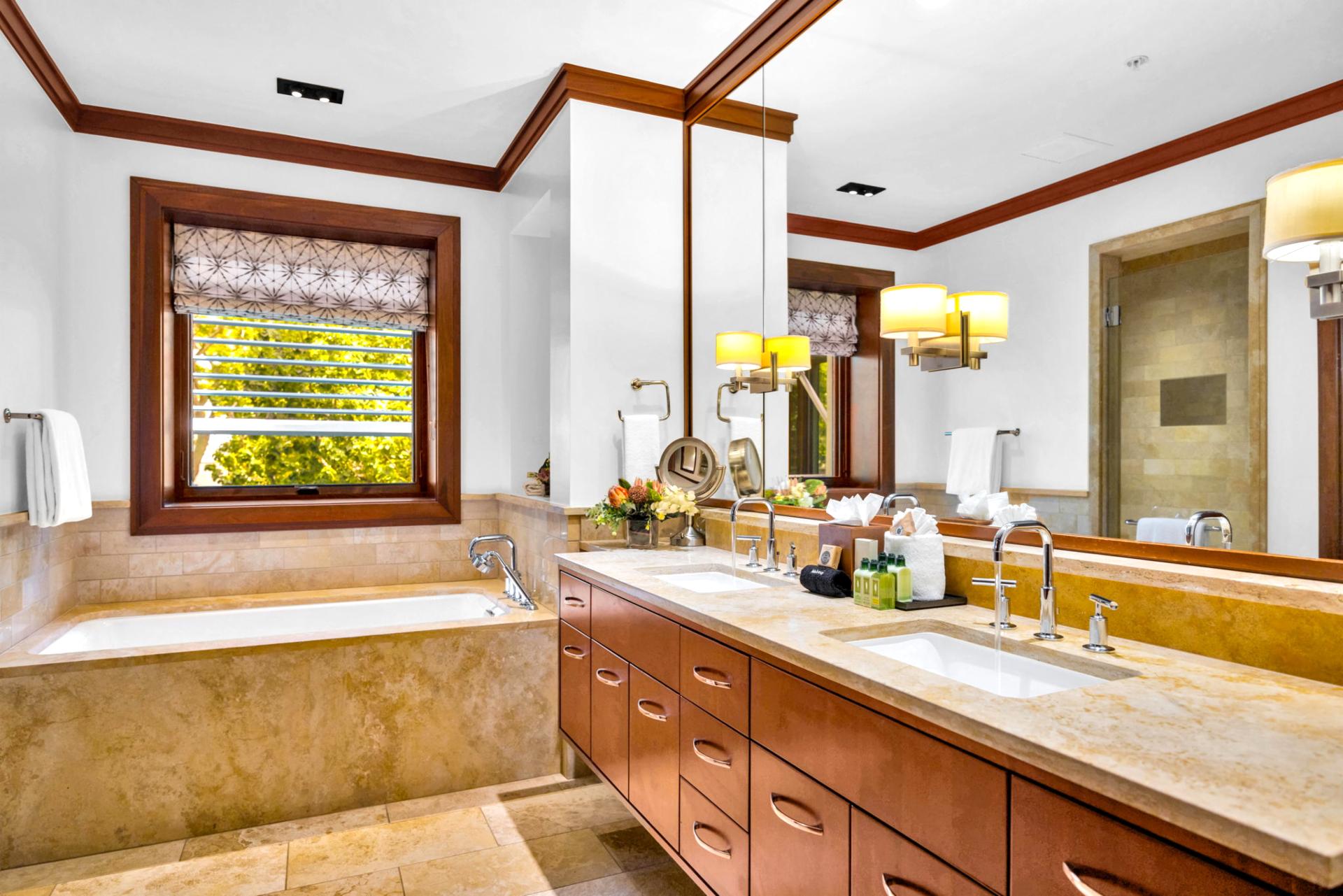 The first guest bath features a double vanity and elegant soaking tub