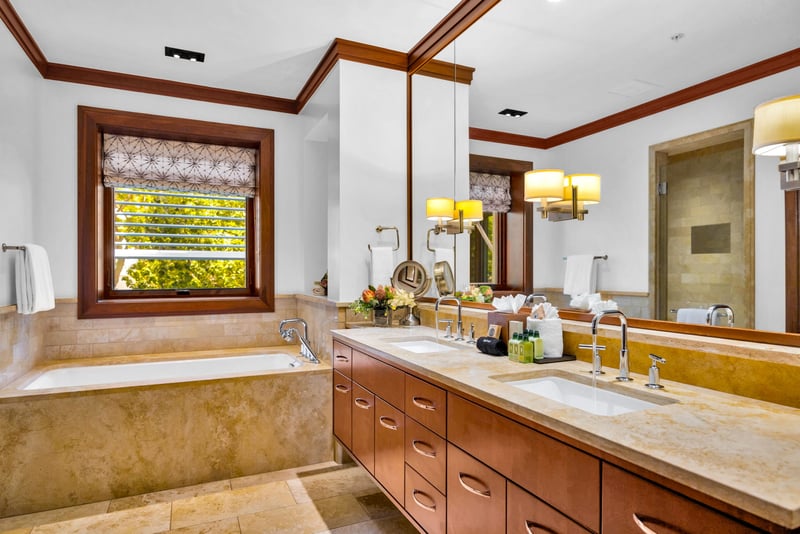 The first guest bath features a double vanity and elegant soaking tub