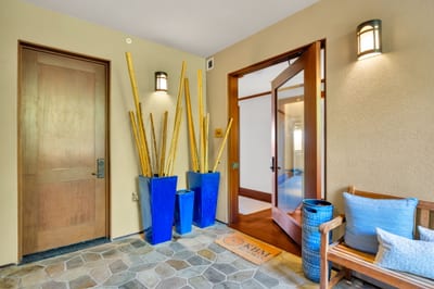 The welcoming entryway features tropical decor