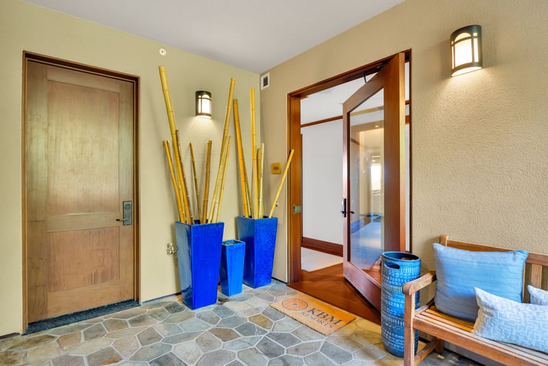 The welcoming entryway features tropical decor