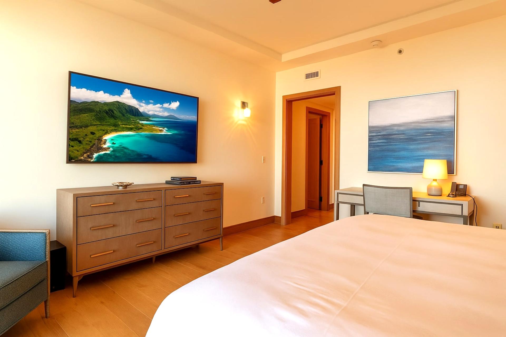 A serene master suite with a plush king bed opens to a private lanai, where comfort meets coastal sophistication