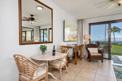 Breezy dining area with rattan chairs and glimpses of the sea NAP-B13