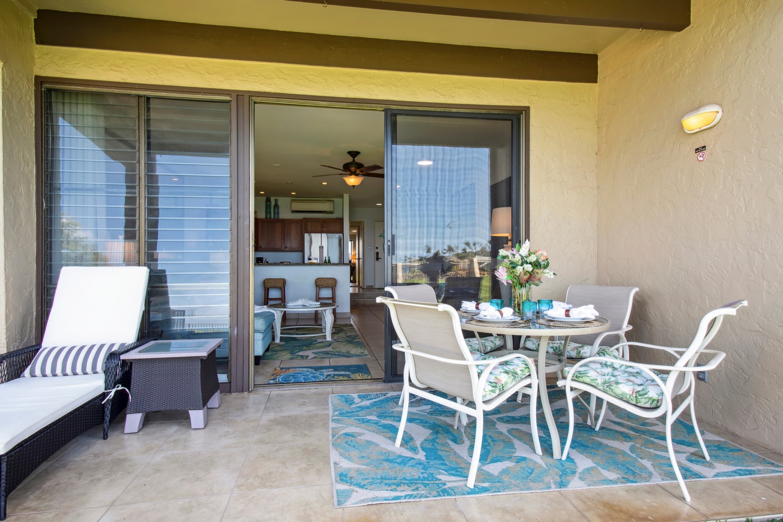 Shaded dining space on the lanai with ocean views NAP-B13