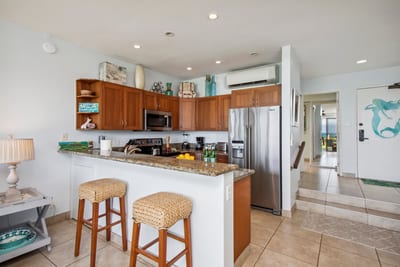 Modern kitchen with bar seating and updated, stainless steel appliances NAP-B13