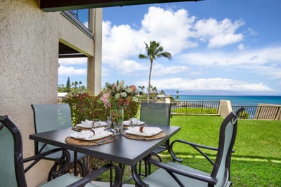 Dine al fresco by the ocean with a serene view, swaying palms, and island breeze.