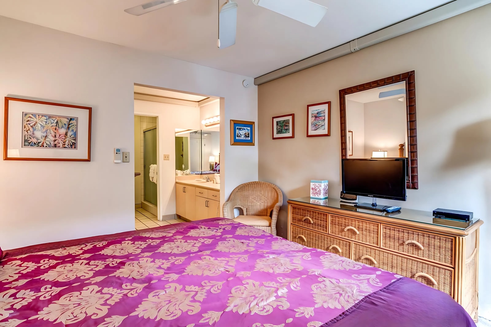 Sink into comfort in this spacious master bedroom with a plush bed, elegant wood furnishings, and calming neutral tones. NAP-B43