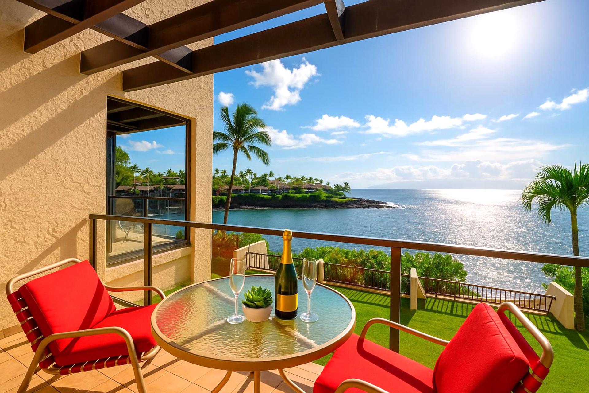 Unwind on this oceanfront lanai with bold red loungers, panoramic coastal views, and golden-hour light on the water