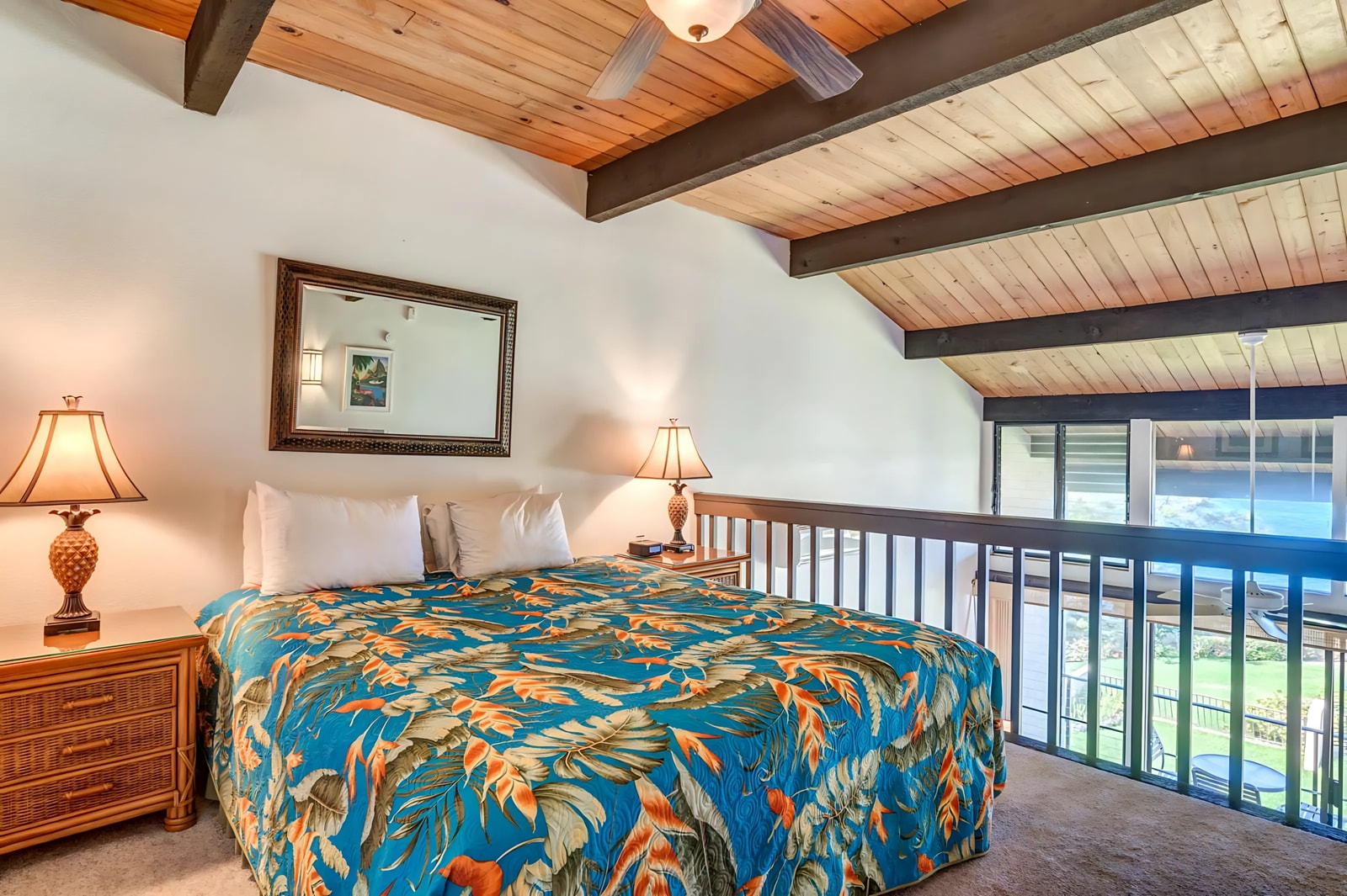 Wake up to soft light in this open-air loft bedroom with vaulted beams, lush views, and cozy island-style decor   NAP-C42