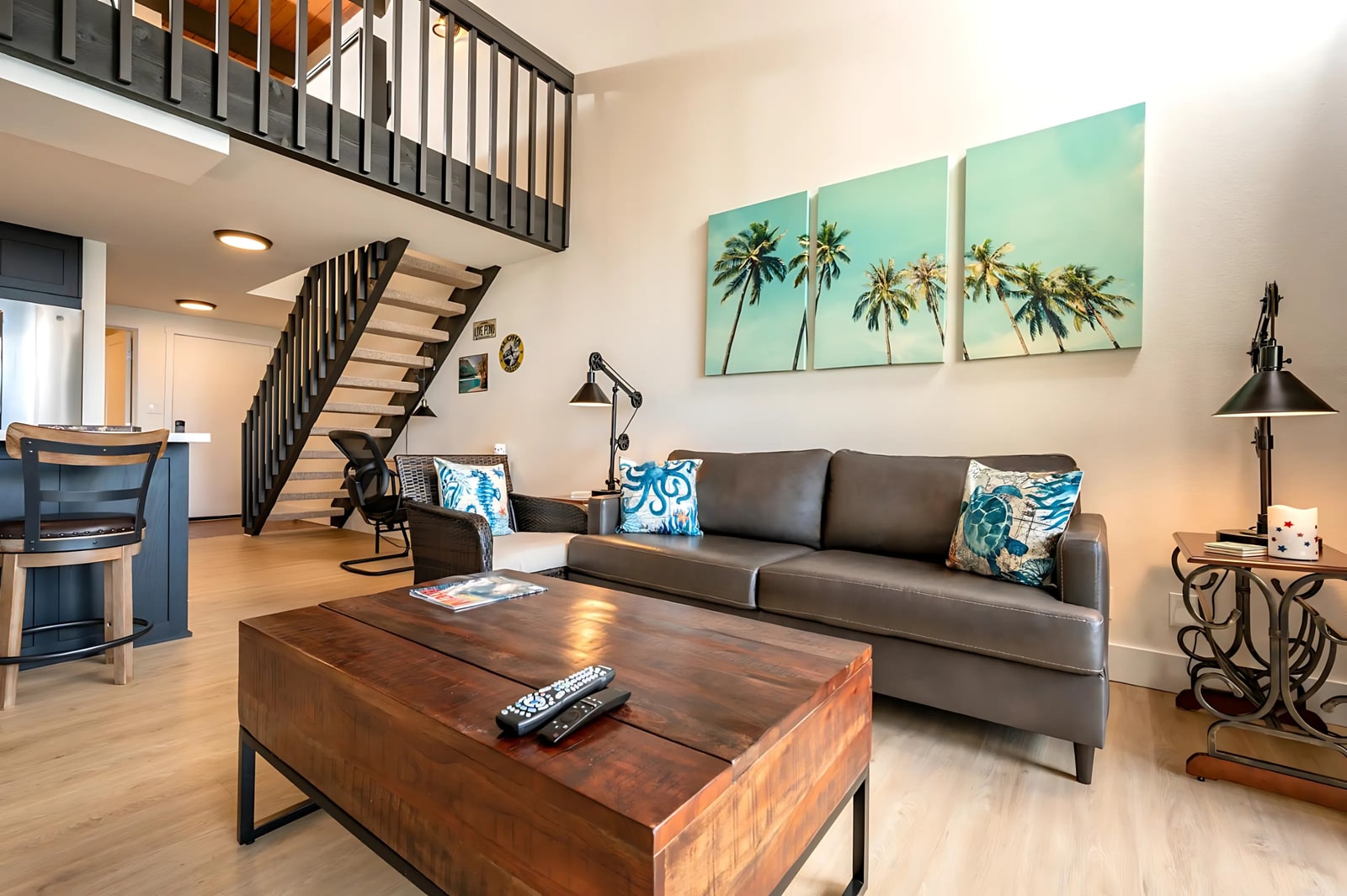 Soak up the sea from plush leather seating as palm prints, woven accents, and warm wood elevate every detail  