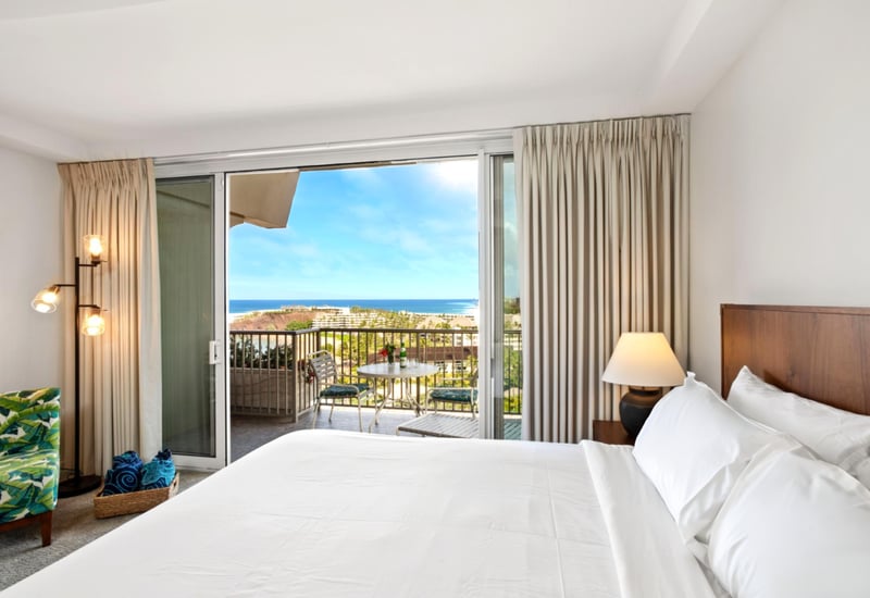 Wake to dreamy skies and swaying palms from a plush bed, with breezy elegance and tropical joy all around
