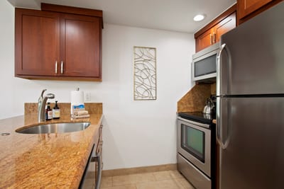 With smooth stone counters and cherry-toned charm, this cozy kitchen stirs up comfort and a hint of wanderlust