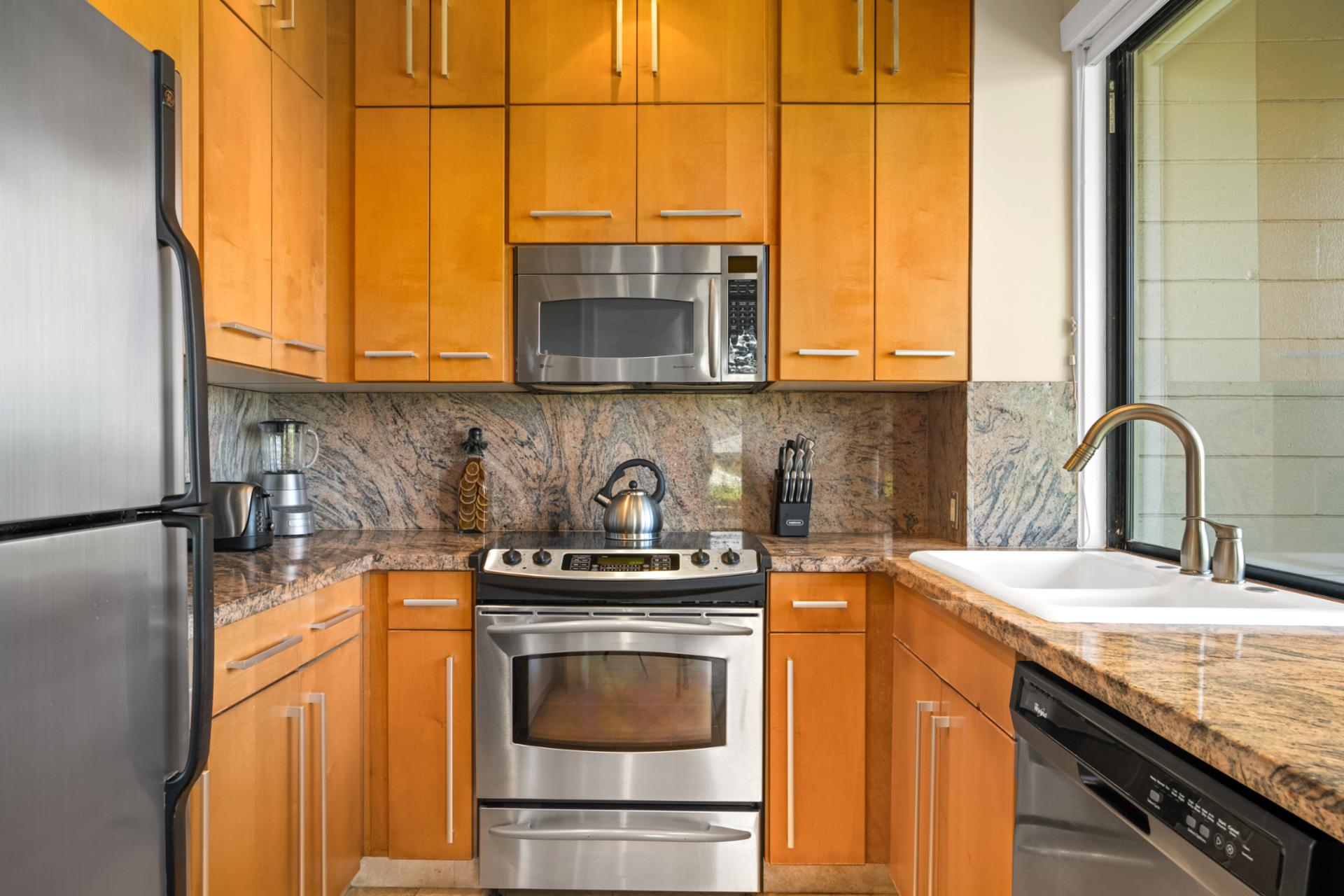 Sleek and functional kitchen space with granite countertops and warm wood cabinetry