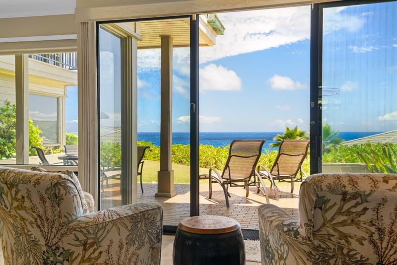 A comfortable lounge area perfect for relaxing after beach days framed by garden views