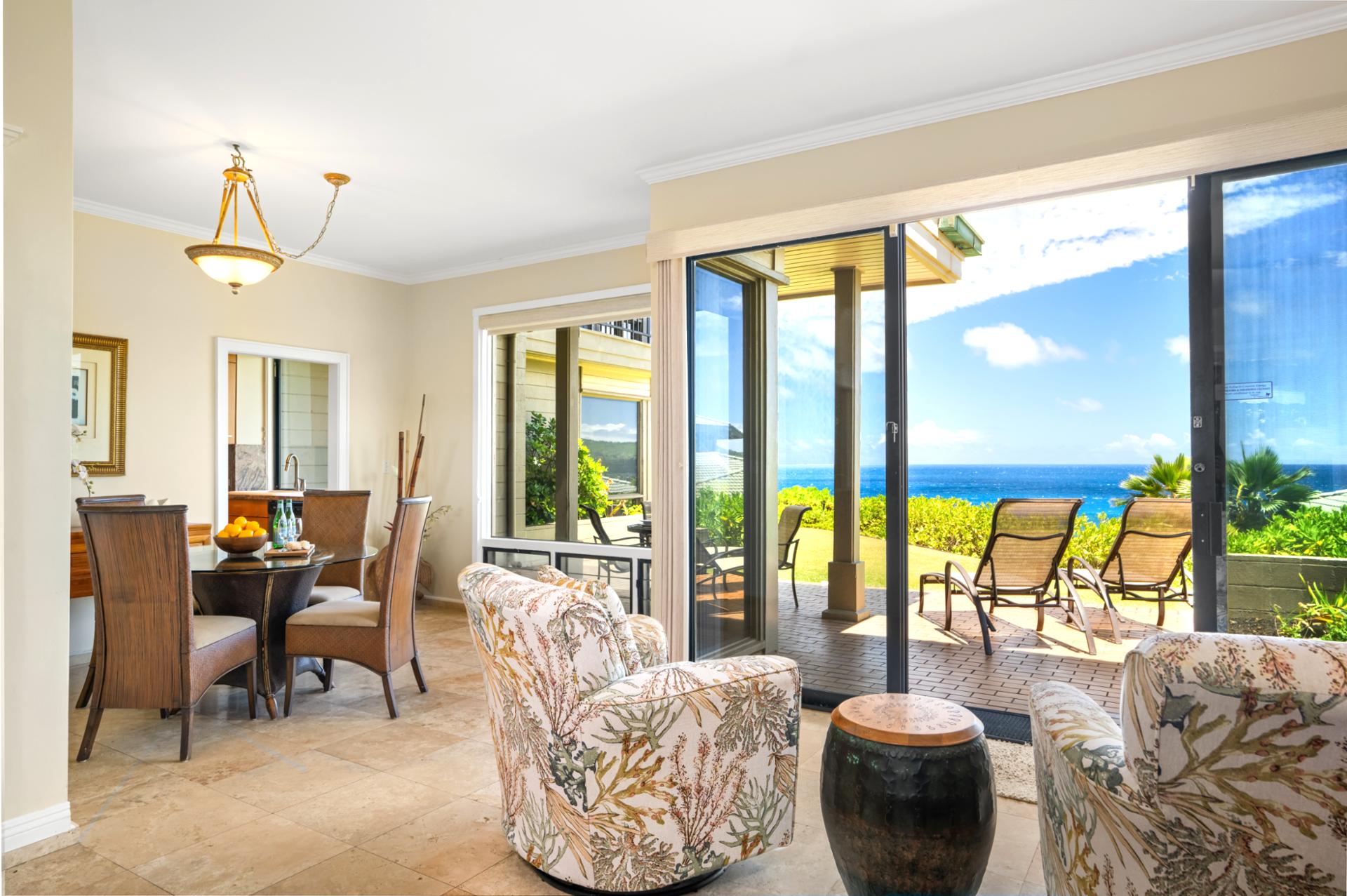 This bright and airy living space offers seamless flow to the lanai and lush surroundings