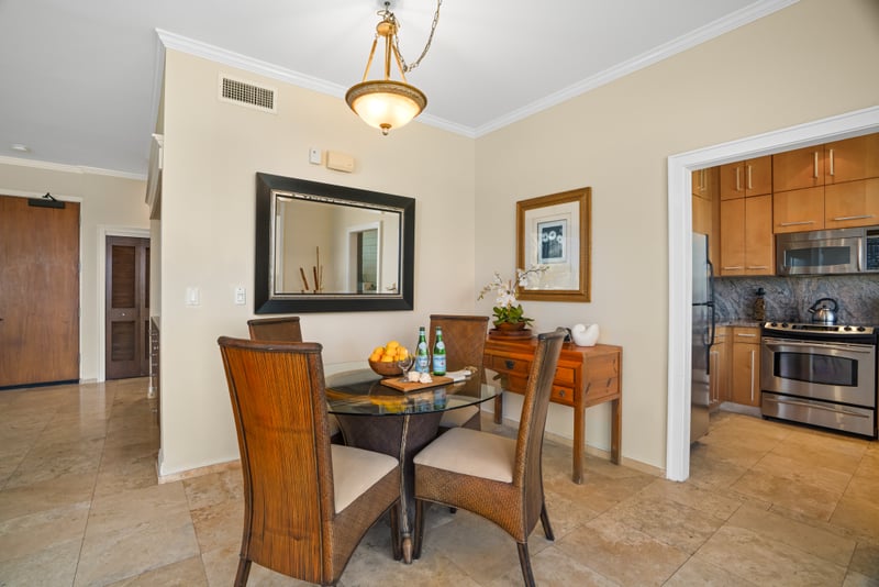 Elegant dining area adjoins a sleek kitchen in a beautifully lit open plan