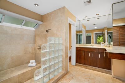 Refresh in a serene bathroom retreat with a glass block shower and modern vanity KBV-34G4