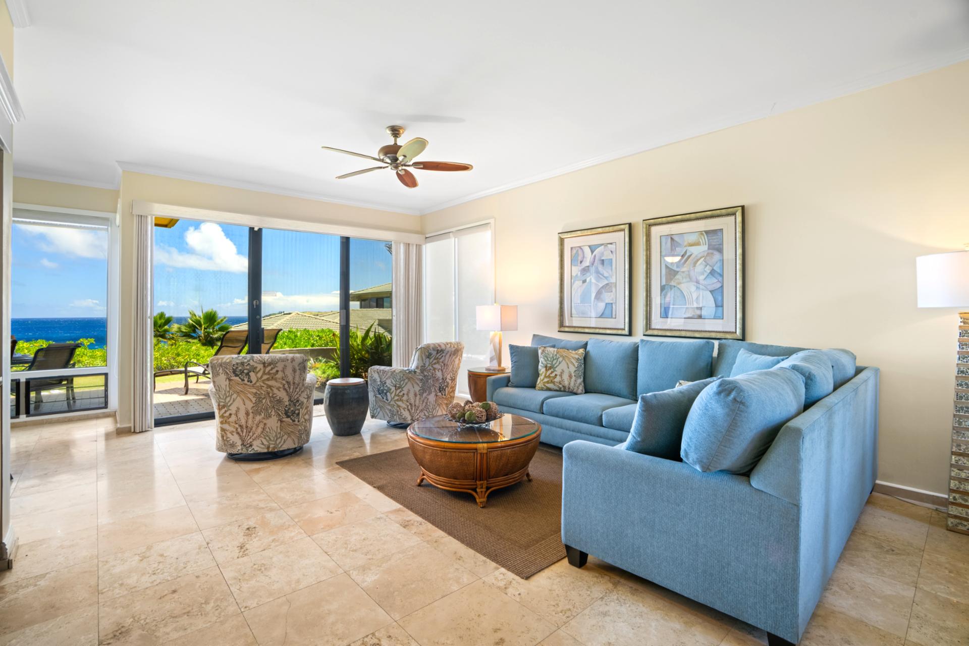 This bright and airy living space offers seamless flow to the lanai and lush surroundings