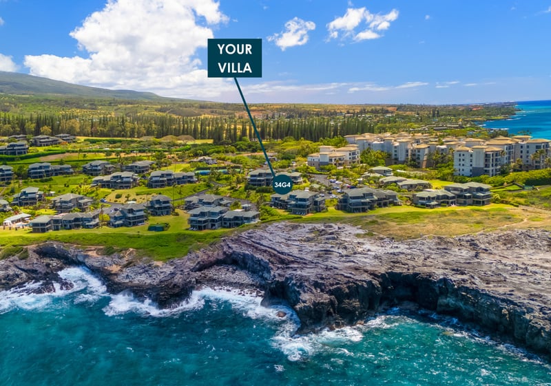 Aerial view of Kapalua Bay Villas marking Villa 34G4's location along the lava rock coastline, with the West Maui Mountains beyond.